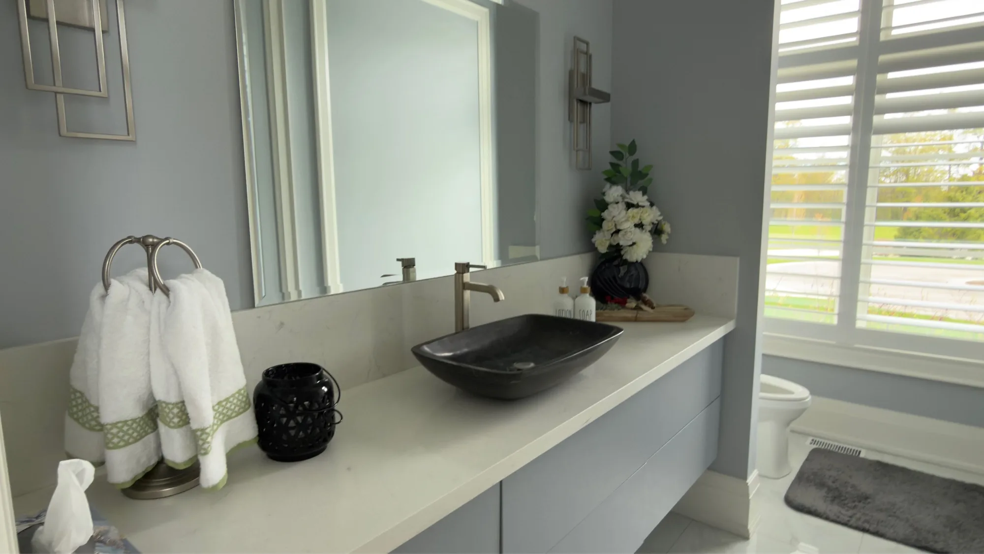 Master bathroom with stone vessel sink on quartz floating vanity and plantation shutters — D&D Interior Services Kitchener-Waterloo